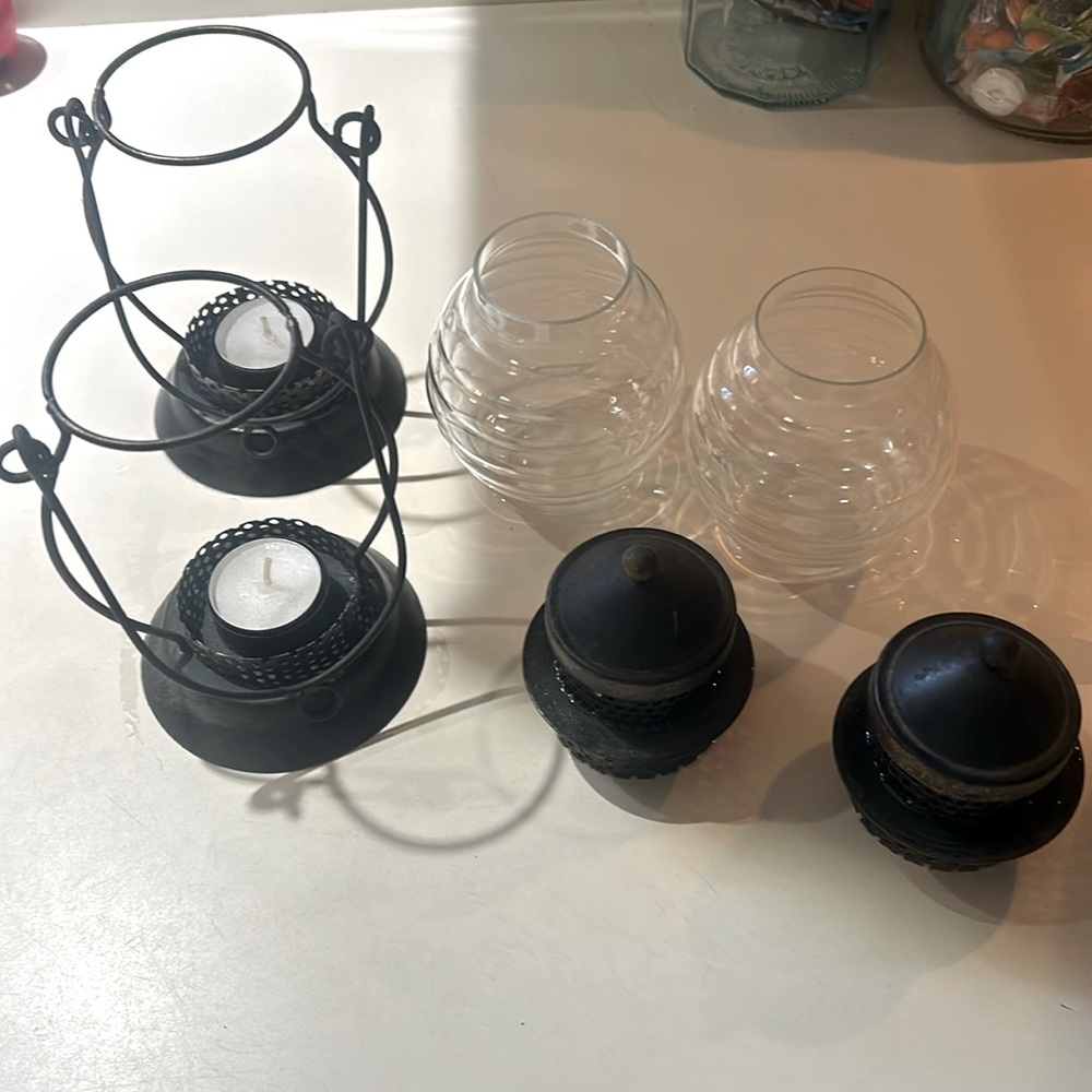 2 rustic hurricane lanterns with candles
